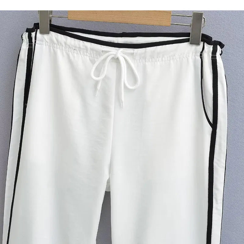 Women's navy blue parallel bars contrast colour loose straight leg trousers on a low waist.