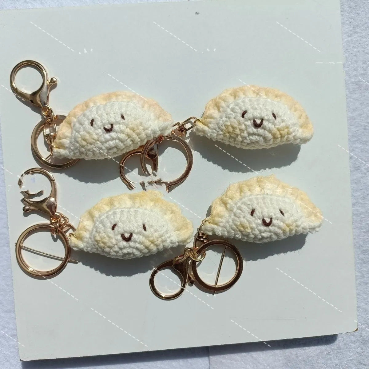 Handmade crochet dumpling pendant with keychain in plush material with two hand-stitched eyes