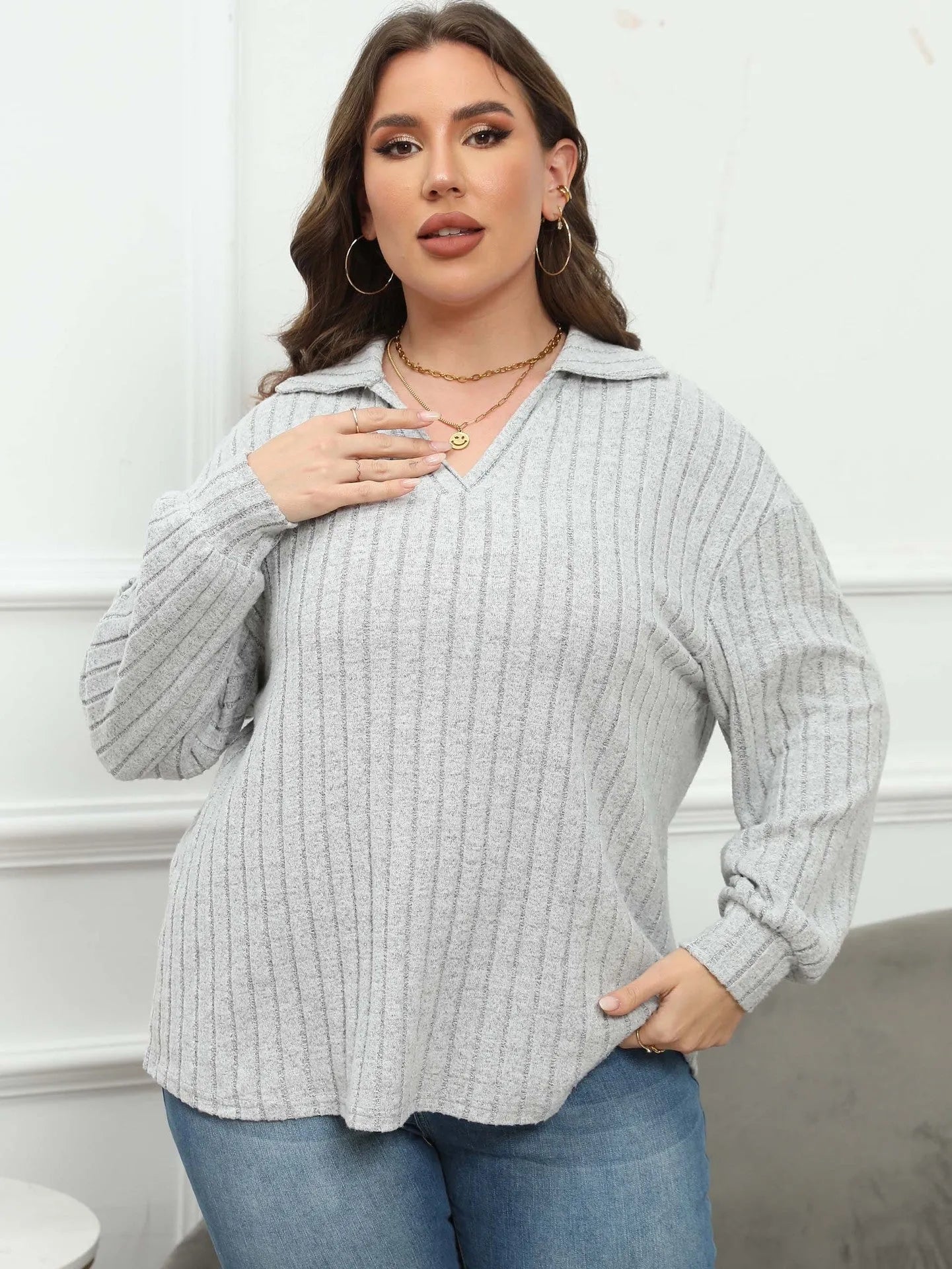 Women's plus size grey polar fleece shirt with a polo collar and lantern sleeves.