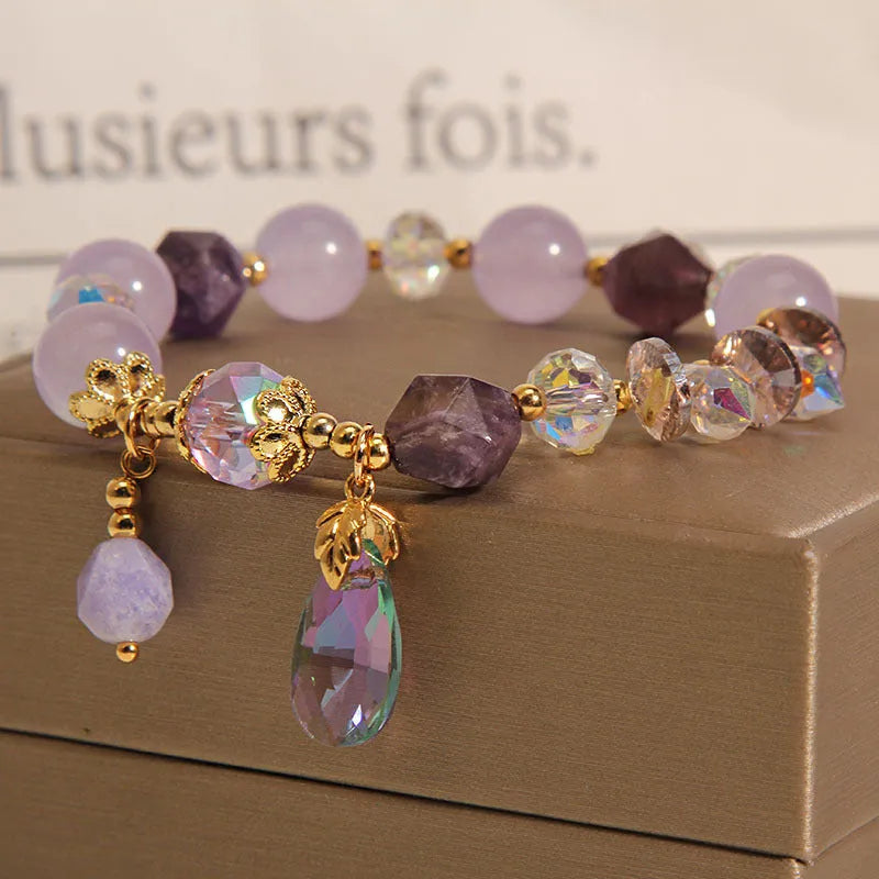 Lavender purple crystal water drop bracelet for children on display, retro original design