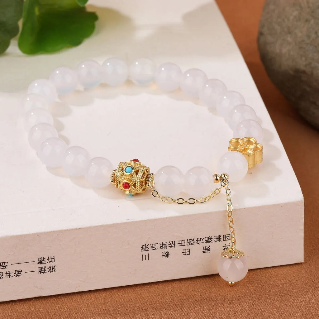 Natural red agate bracelet with 8mm beads and copper peach blossom parts on wrist