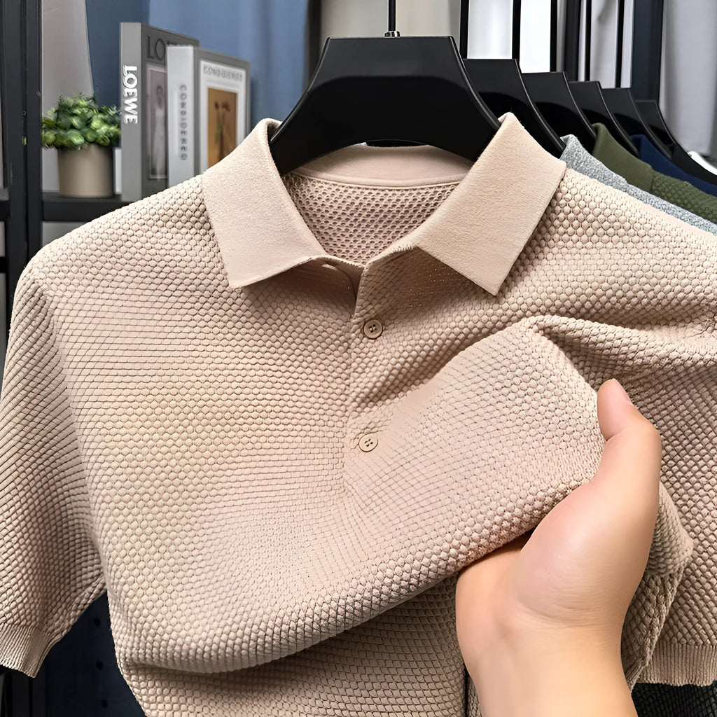 A loose short-sleeved cotton pullover sweater on a hanger, shown in a solid colour.