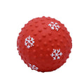 Red dog toy ball with snowflake print pattern, 7cm diameter, bouncing on grass