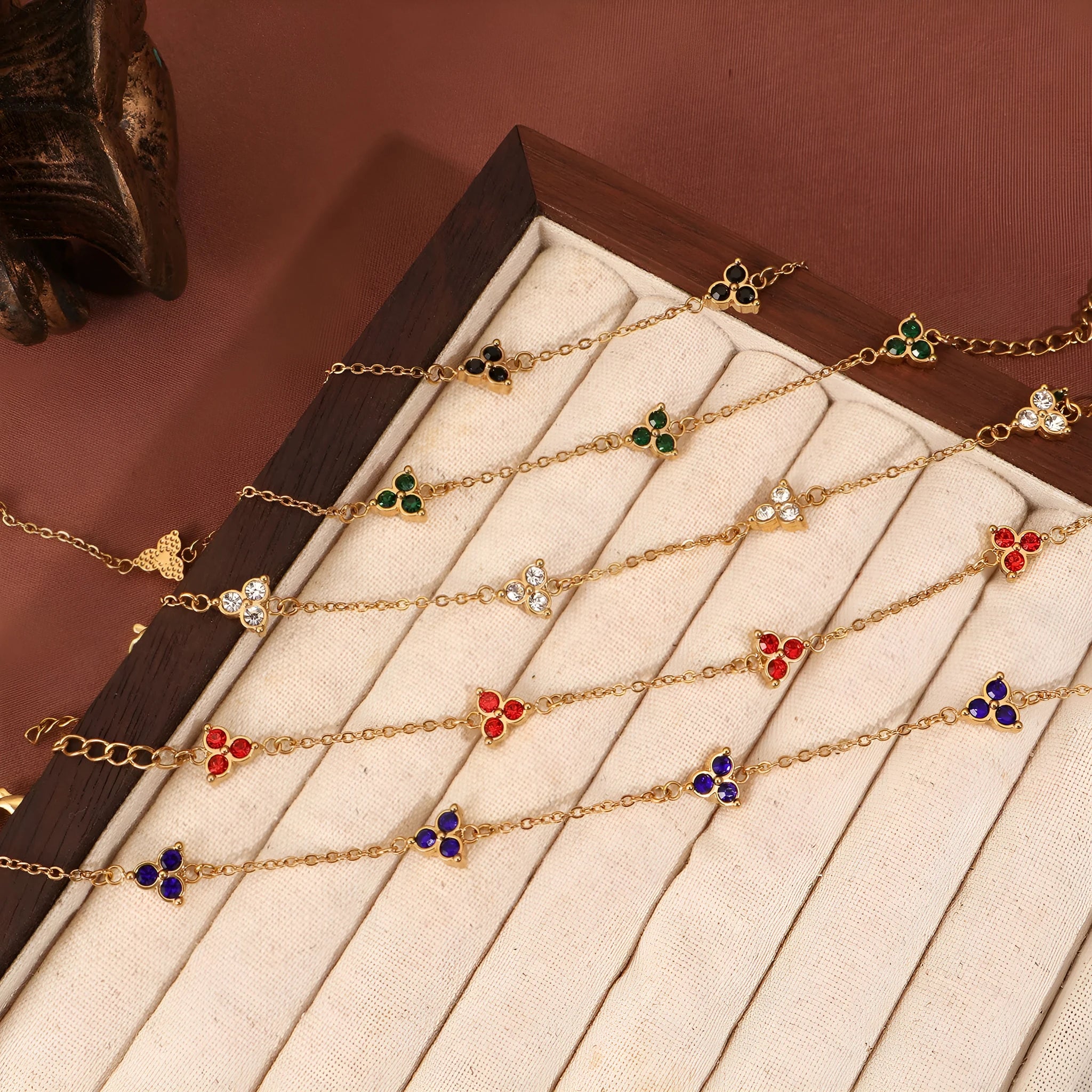 Women's stainless steel bracelet with three triangular diamond charms in geometric design with coloured stones