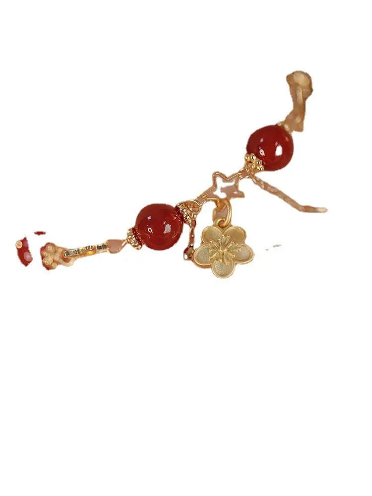 Red agate double layer bracelet with floral and peach blossom charms on adjustable band