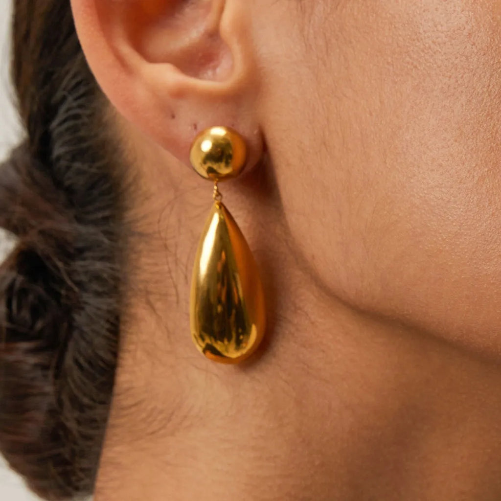 Gold electroplated stainless steel water drop pendant earrings with a geometric hemisphere design.