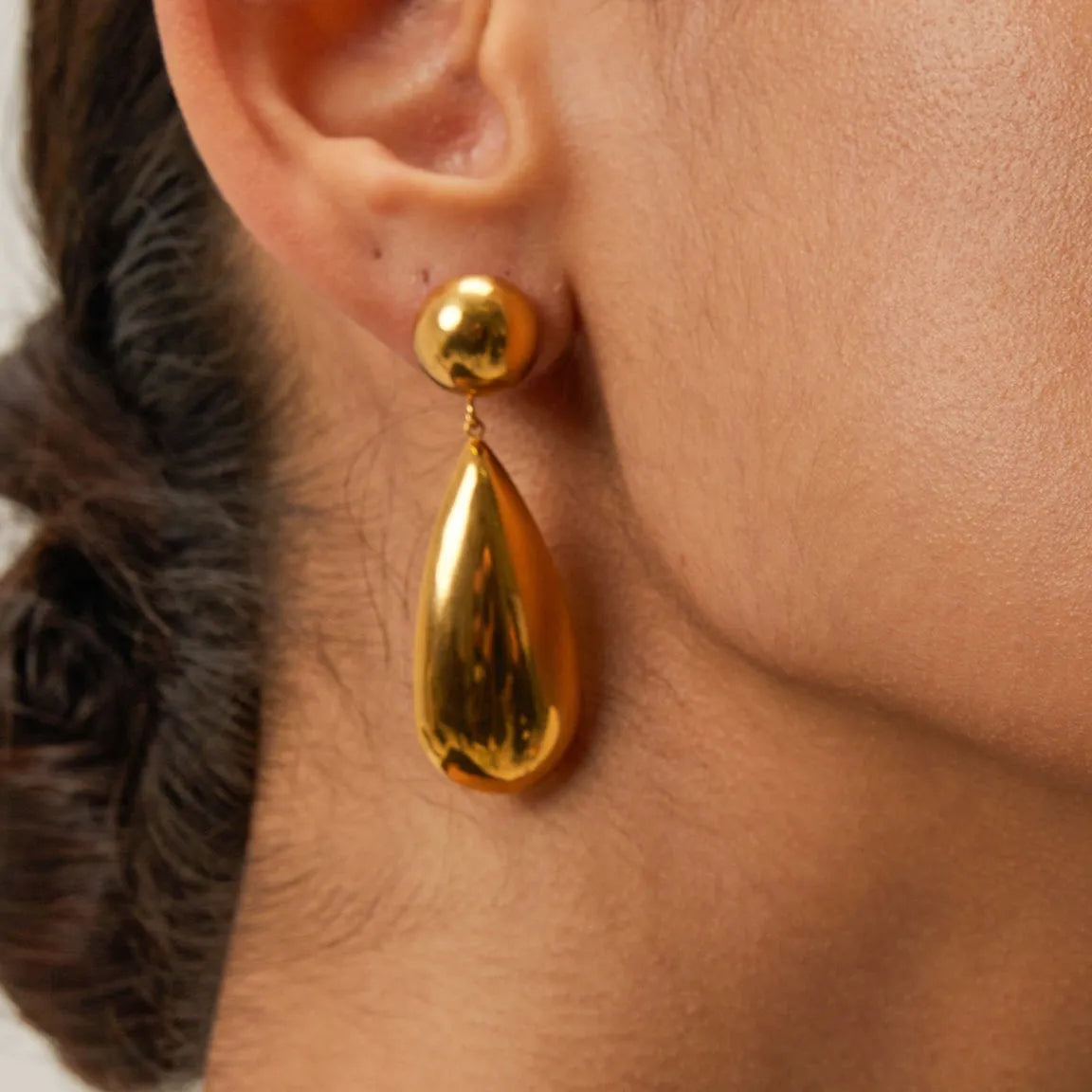 Gold electroplated stainless steel water drop pendant earrings with a geometric hemisphere design.