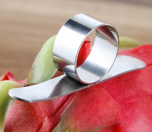 Silver stainless steel ring peeler for citrus fruits on a white background