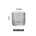 Clear glass cup and pot set with striped and diamond pattern designs for whiskey or wine