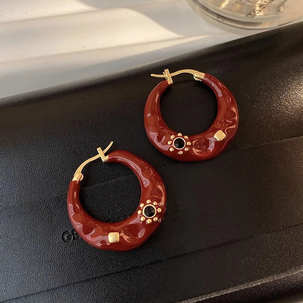 Retro style ear studs with dripping oil finish and rhinestone detailing in black and red colours