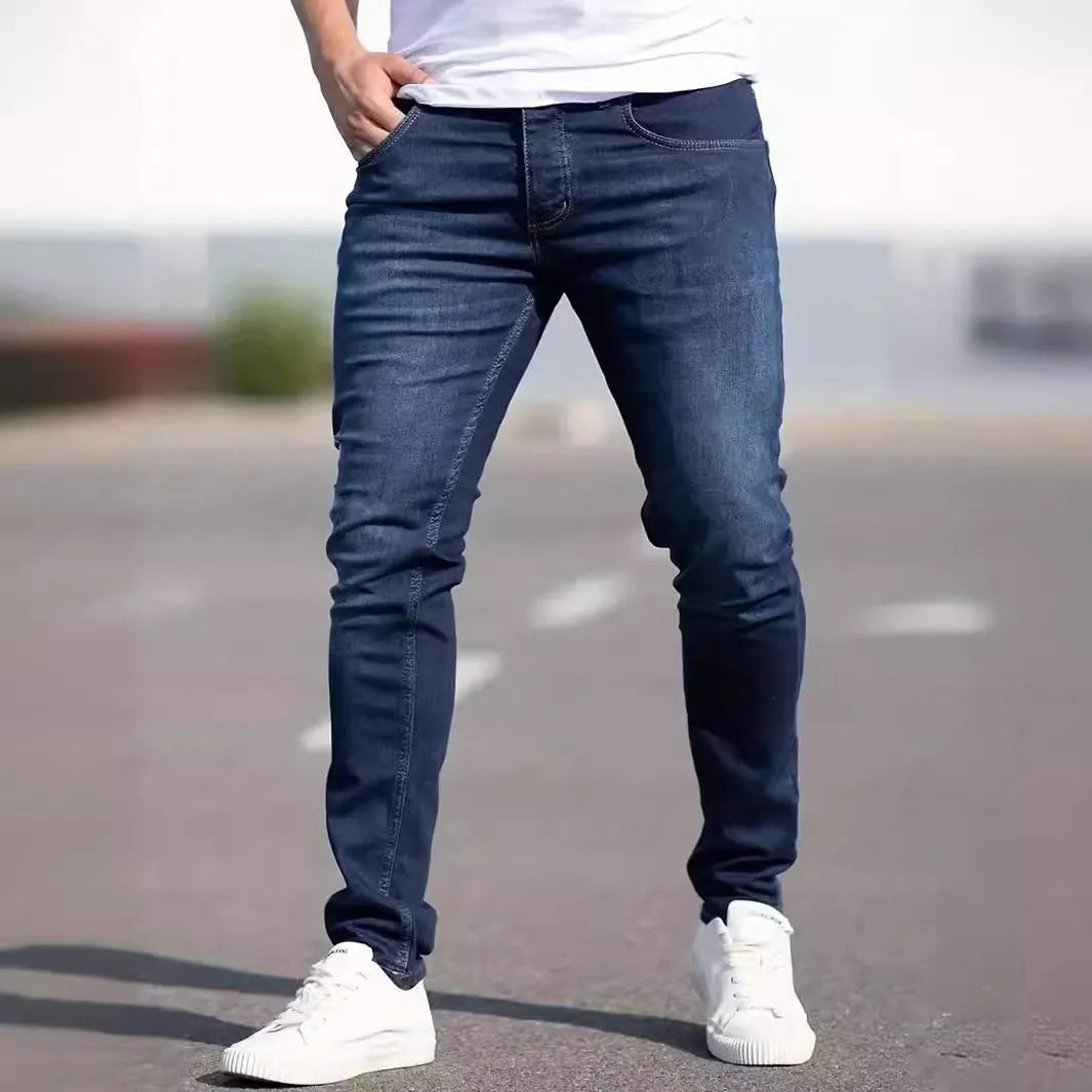 Dark blue men's slim fit skinny jeans with stretch cotton fabric on a mid waist.