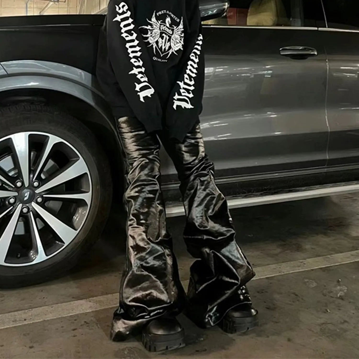 Black coated shiny patent leather straight-leg skinny jeans on a mid-waist