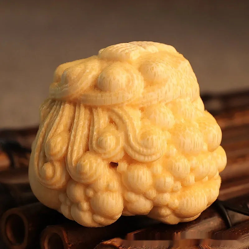 Solid bamboo carving of a cute Golden Toad Princess ornament on a white background.
