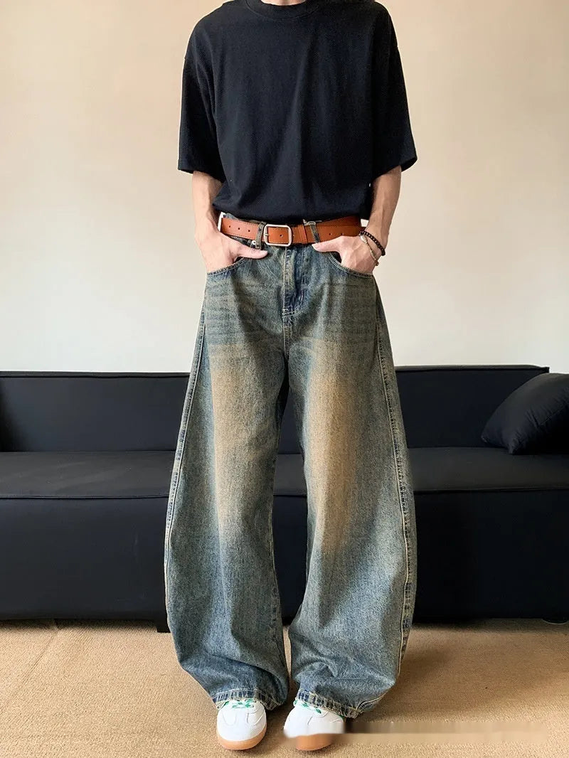 Men's retro blue distressed denim trousers with wide leg cut and vintage wash detailing