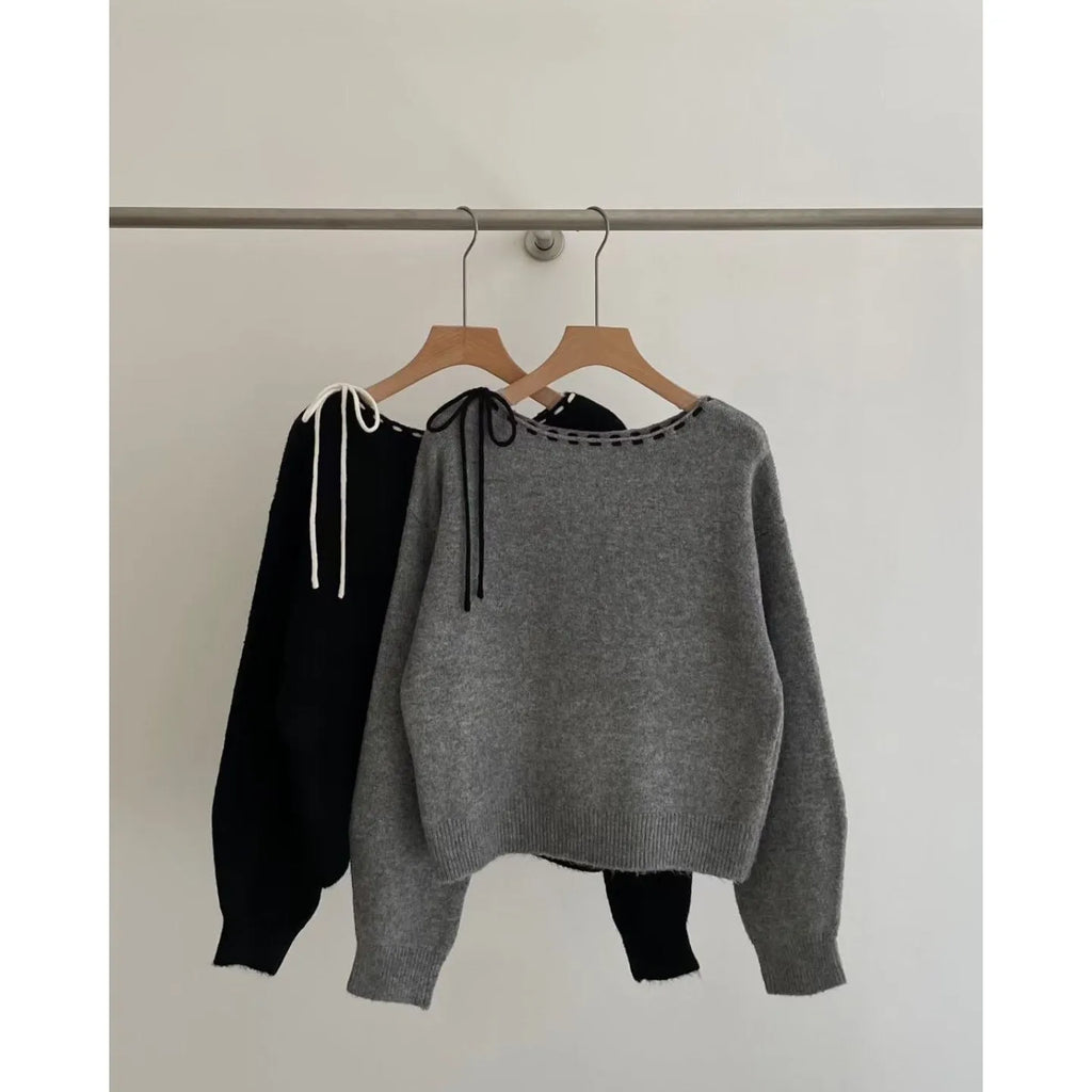 Grey loose-fit women's pullover knitwear on a hanger