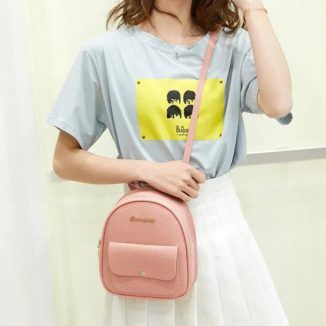 Black PU leather small women's backpack with zipper, shown as a shoulder bag
