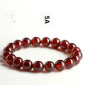 Natural orange red garnet ball bracelet with ruyi charm showing crystal construction and spherical gemstones