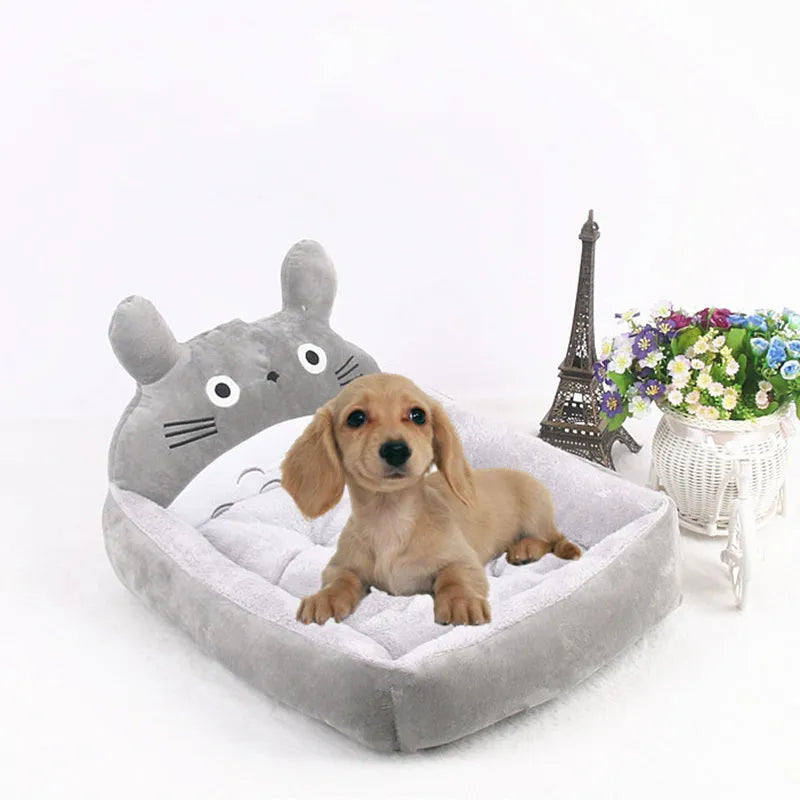 A blue cartoon-style sofa bed for a small dog or cat, with soft raised sides.