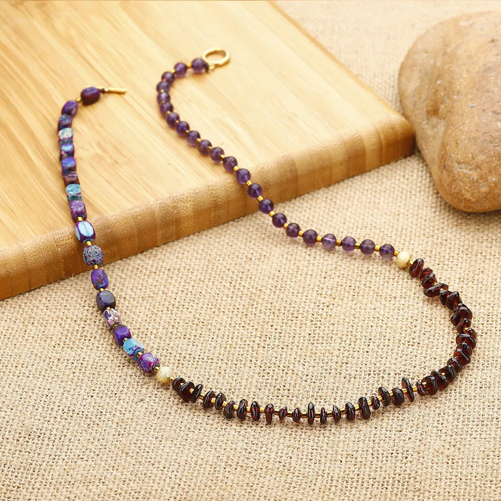 Amethyst round beads stone bracelet with purple garnet and geometric texture on plain background