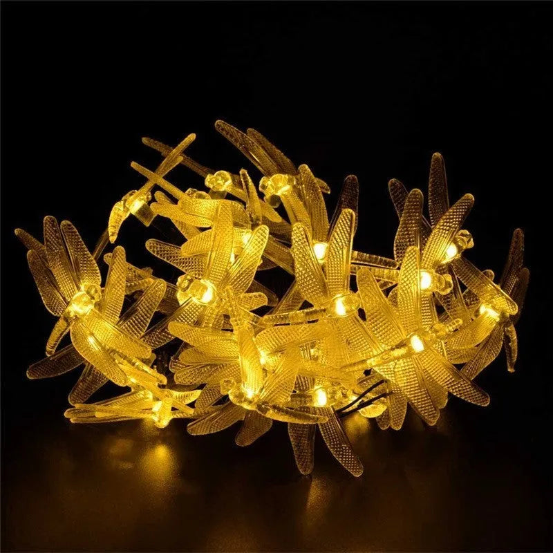 Outdoor solar LED string light with 30 warm white LEDs on 6-metre cable, solar panel with ground spike, and IP65 waterproof rating