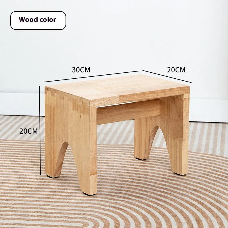Solid wood distressed finish changing stool with bracket structure.