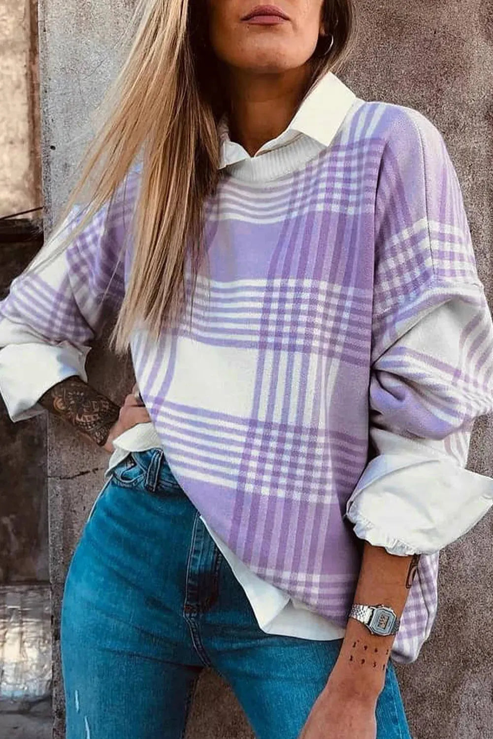 Lilac plaid print loose sweater with ribbed trim and long sleeves on a hanger