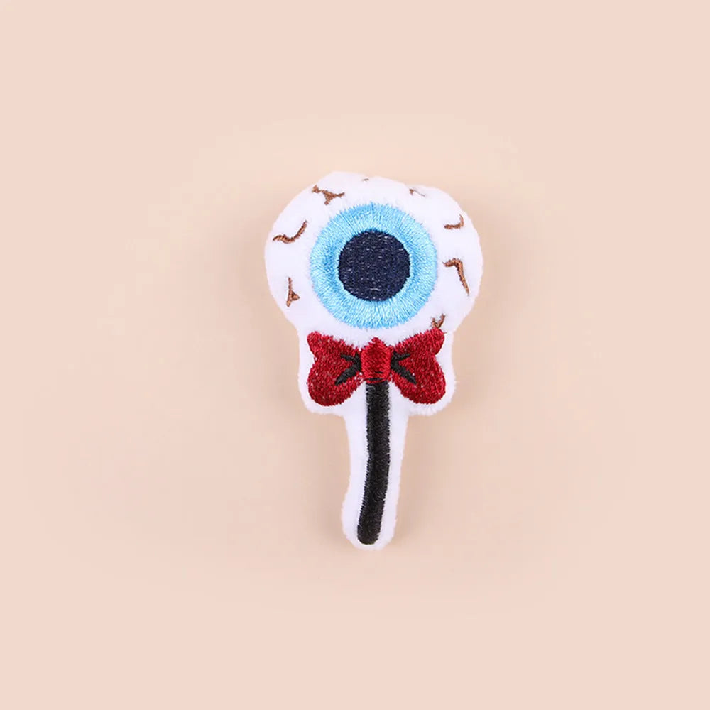 Small plush cat teaser wand with replaceable candy and skull head designs for interactive feline play