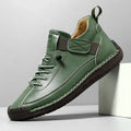 Men's mid-calf Martin boots in khaki with tooling stitching and an elastic band closure.