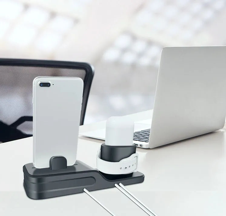Black 3-in-1 silicone charging base for iPhone, iWatch, and AirPods on a desk