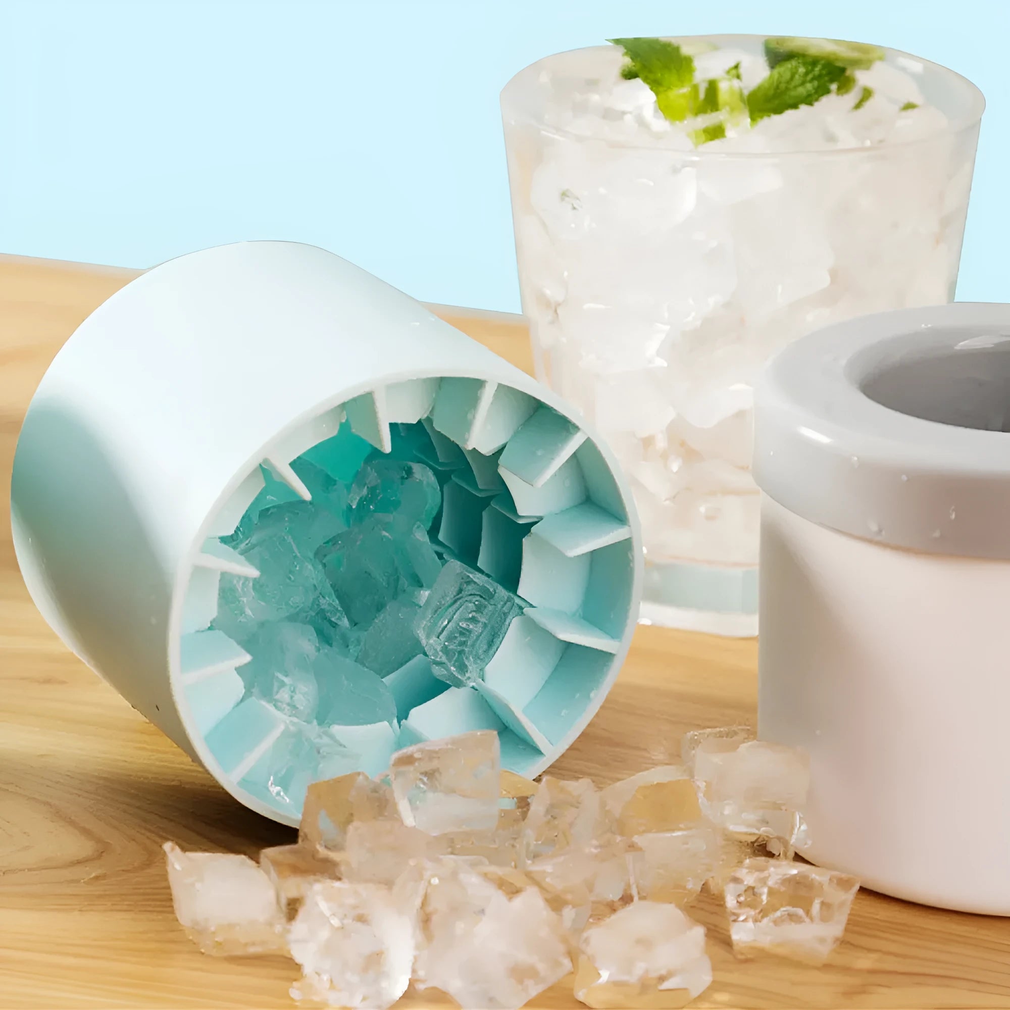Portable 2-in-1 silicone ice bucket mold with lid in blue-green on a white background