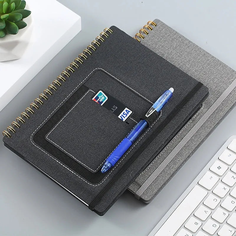 A5 coil-bound erasable notebook with waterproof stone paper in a customisable cover, shown with a pen.