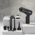 Black wireless car vacuum cleaner with multiple nozzle attachments including brush heads and suction tubes