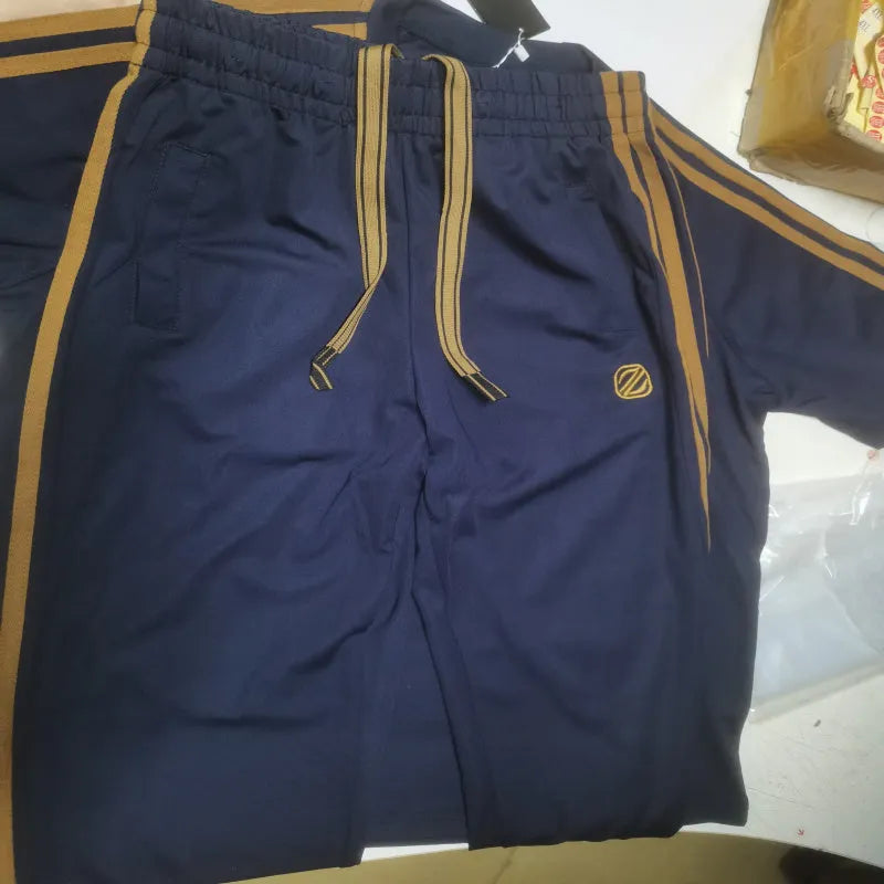 Man wearing a blue short sleeve polyester sports suit, top and trousers, ironing-free and breathable.
