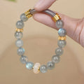 Light green emerald Tian Shan Cui half bracelet with floating flower girl motif on white background