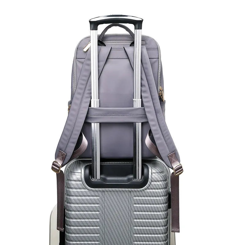 Oxford cloth women's backpack in black and purplish grey, showing large capacity and design features.