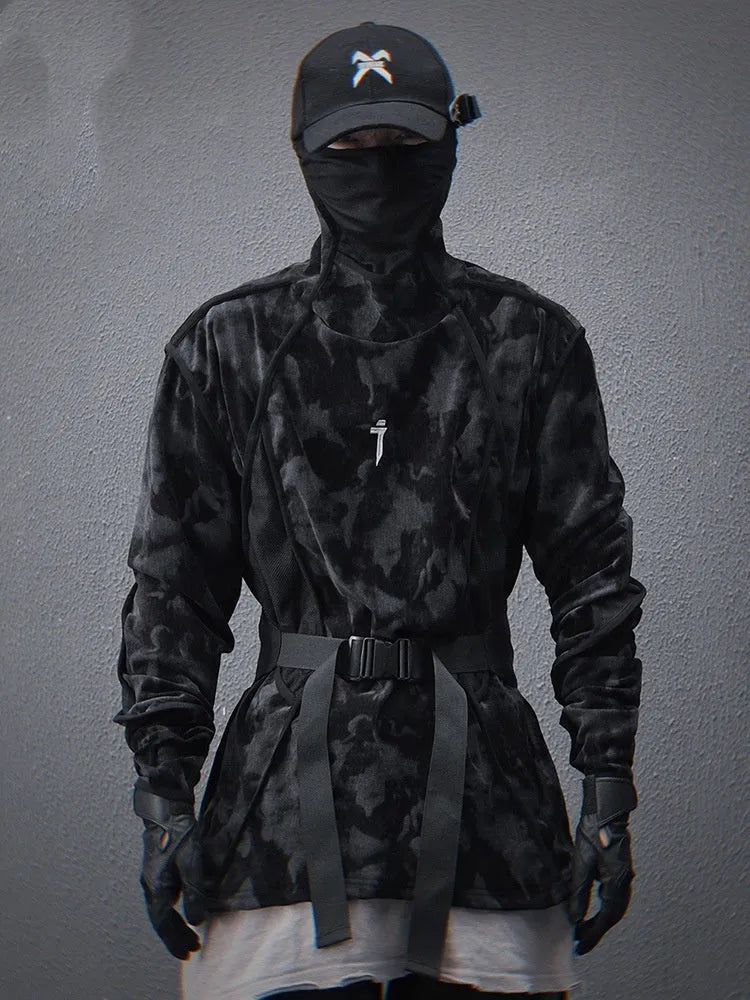 Man wearing a black tie-dye printed sweater with a finger turtleneck and drop-shoulder sleeves.