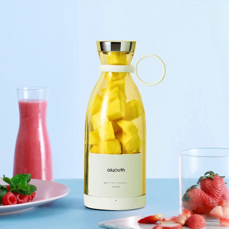 Handheld small electric portable mini juicer in pink with USB charging port and four cutter head
