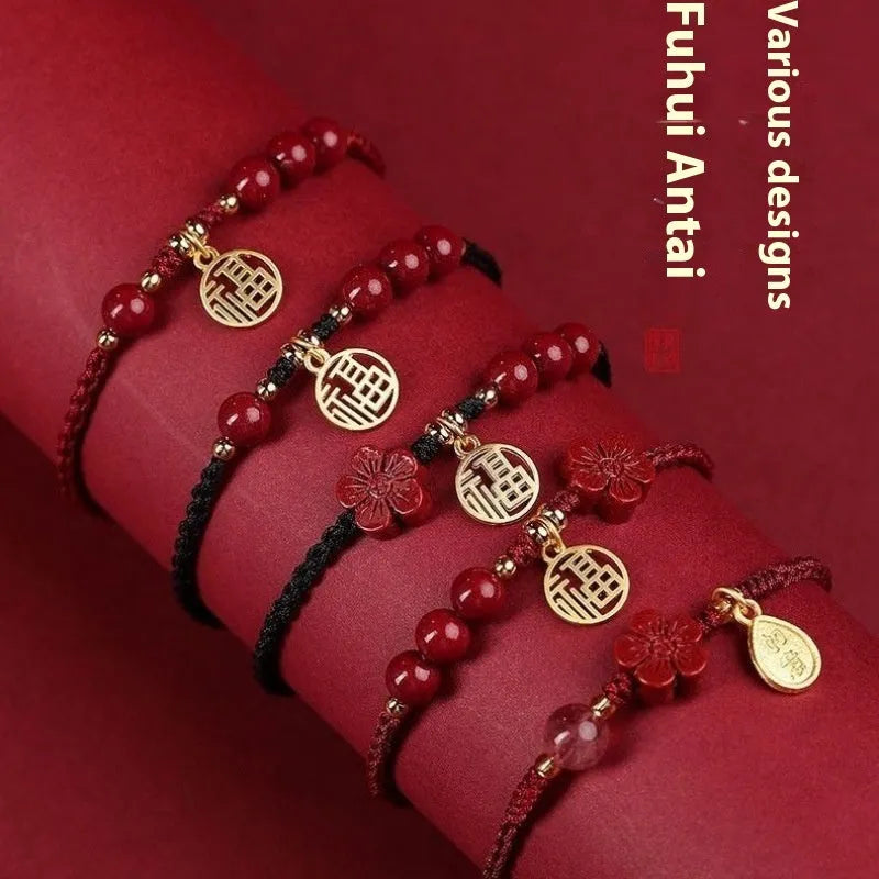 Cinnabar birth year braided rope bracelet with round bead blessing card in wine red colour on a plain background.
