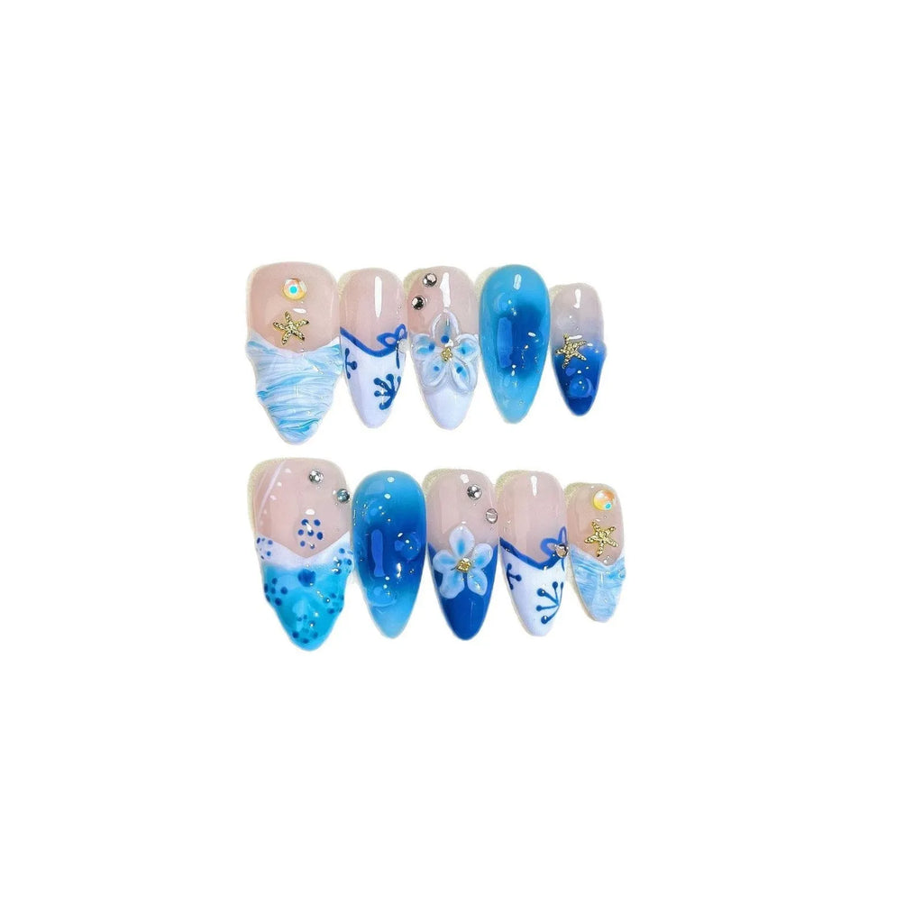 Set of blue transparent false nails with hand-painted carved design, showing sizes XS, S, M, L