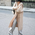 Long grey knitted cardigan trench coat with hood shown on hanger