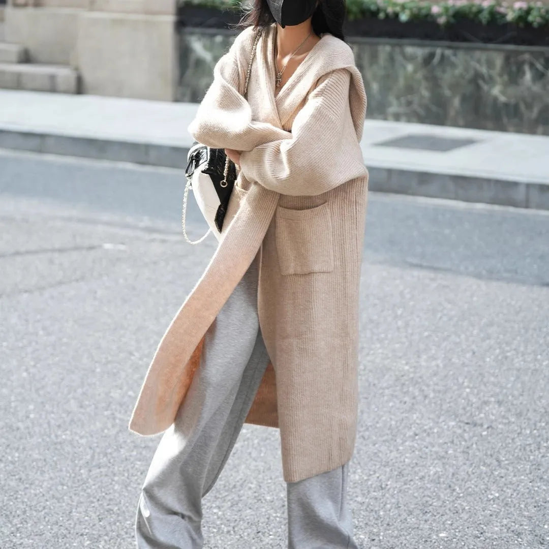 Long grey knitted cardigan trench coat with hood shown on hanger
