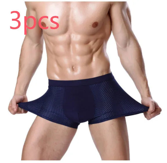 Man wearing dark blue ice silk modal boxer briefs with a U convex design and mid waist fit.