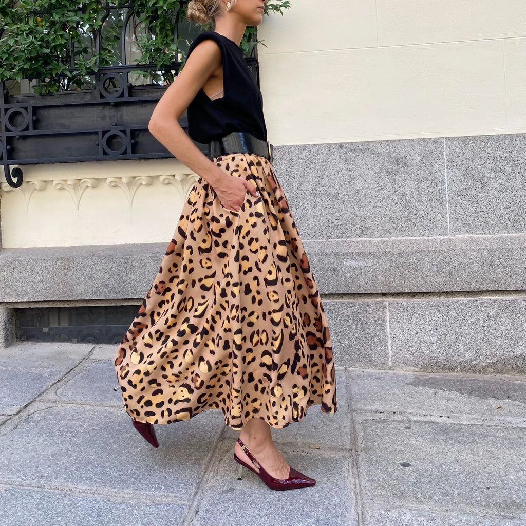 Brown leopard print women's A-line long skirt with a big hem detail on a mannequin.