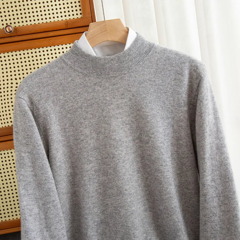 Man wearing a loose-fit half-turtleneck wool sweater in a neutral colour.