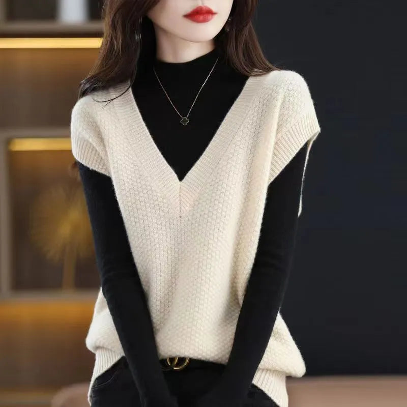 Women's creamy-white V-neck sleeveless knitted vest with 3D pattern texture, laid flat showing front design
