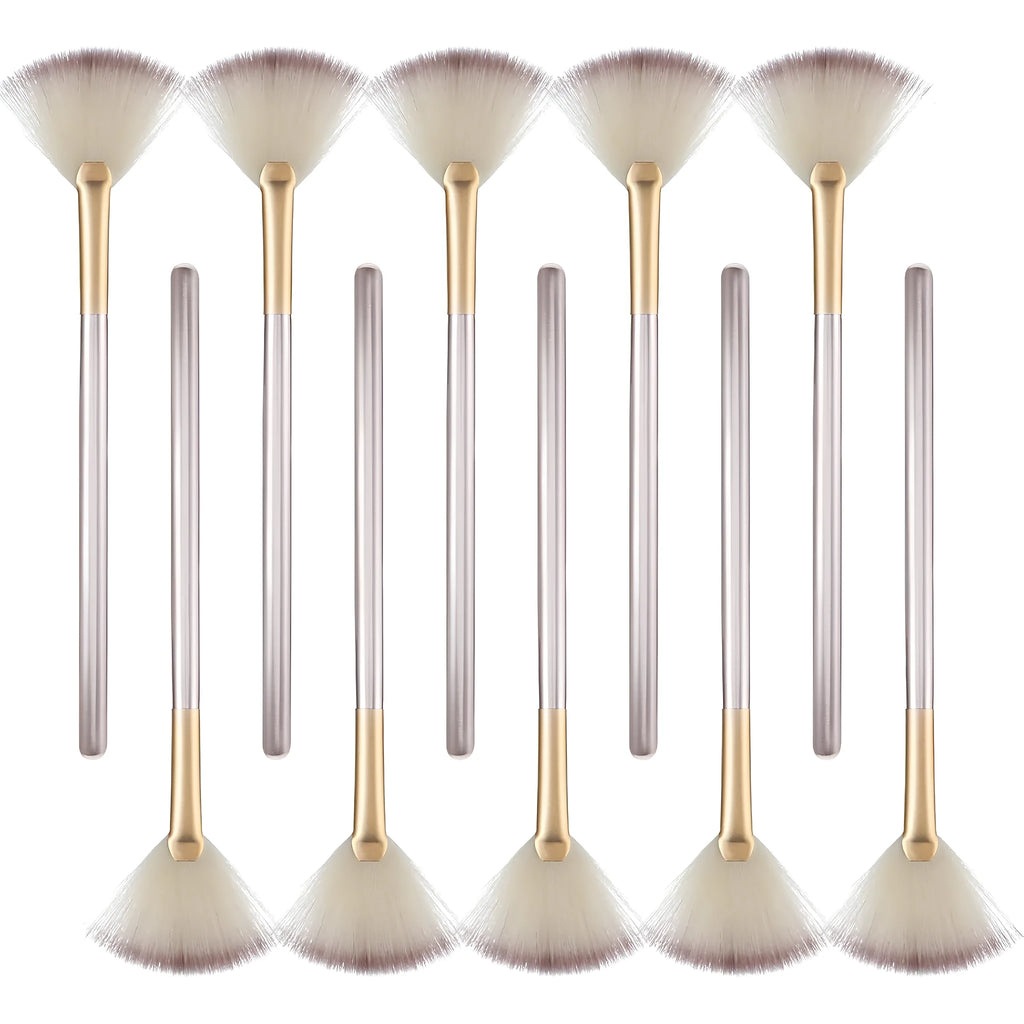 Ten champagne-coloured acrylic handle fan brushes with soft white bristles and clear protective covers.