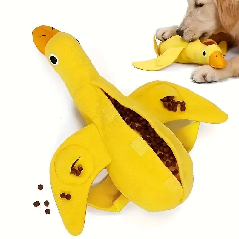 Yellow plush teddy dog toy with a attached duck doll and visible treat pockets on a white background.