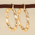 Geometric copper earrings for women with ring and line elements in golden colour