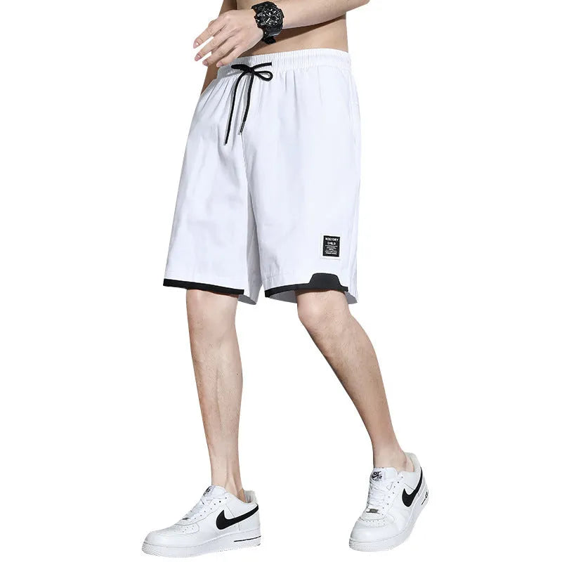 Boys' plus size cotton shorts in black, shown flat, featuring a mid waist and shorts length design.