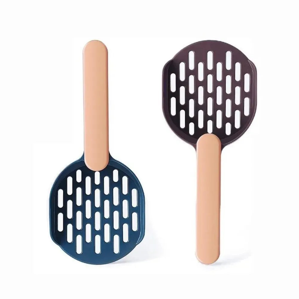Plastic cat litter shovel in blue, green, and pink colours on a clean surface